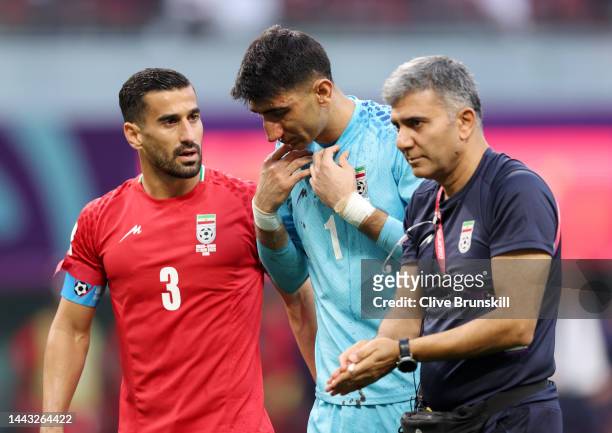 Alireza Beiranvand of IR Iran is attended to after sustaining an injury during the FIFA World Cup Qatar 2022 Group B match between England and IR...