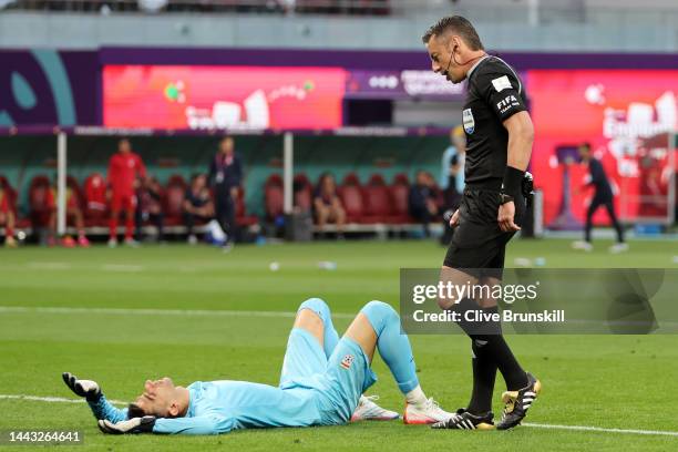 Alireza Beiranvand of IR Iran receives medical treatment during the FIFA World Cup Qatar 2022 Group B match between England and IR Iran at Khalifa...