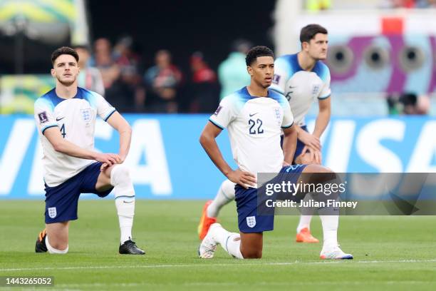 Declan Rice, Jude Bellingham and Harry Maguire of England take a knee prior to the FIFA World Cup Qatar 2022 Group B match between England and IR...