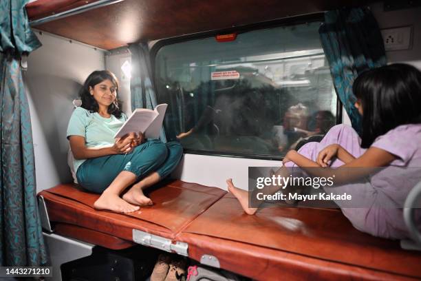 mother and daughter travelling in a/c coach of a train - indian trains stock pictures, royalty-free photos & images