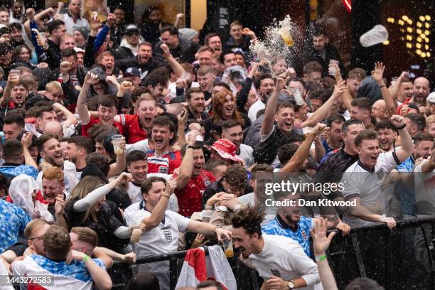 England fans cheer at BOXPARK Croydon as they watch a live broadcast of England's opening group-round match versus Iran on November 21, 2022 in...