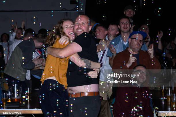 Fans react after the first goal from England as they watch England's opening group-round match versus Iran in the Big Penny Social in Walthamstow on...