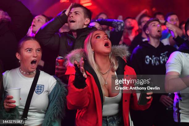 Supporters react as they watch England's first FIFA World Cup Qatar 2022 match against the Islamic Republic of Iran on the big screen at Road to...