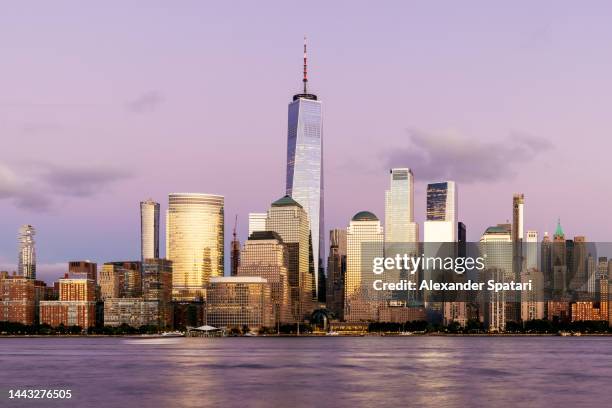 illuminated skyscrapers of manhattan downtown at dusk, new york city, usa - banking district stock pictures, royalty-free photos & images
