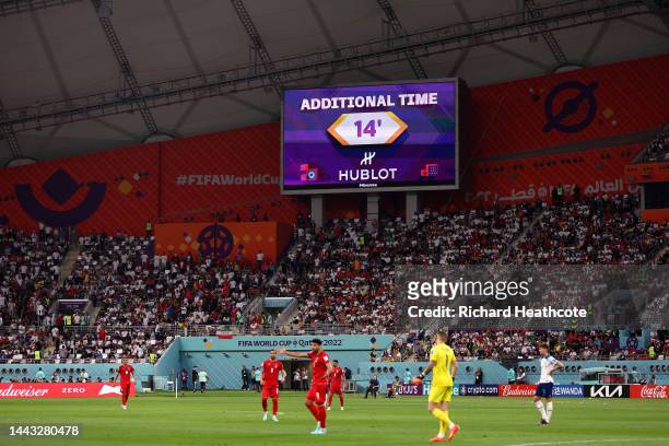 Giant screen displays additional time of 14 minutes as Alireza Beiranvand of IR Iran received medical treatment during the FIFA World Cup Qatar 2022...