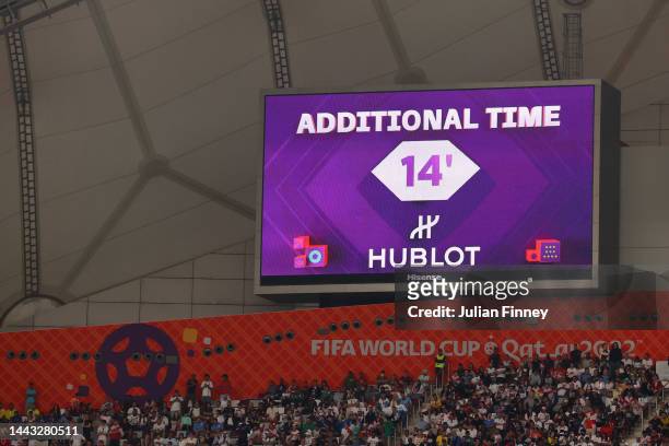 Giant screen displays additional time of 14 minutes as Alireza Beiranvand of IR Iran received medical treatment during the FIFA World Cup Qatar 2022...