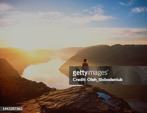 Woman hiking in mountains on the background of Lysefjorden