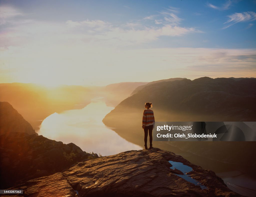 Woman hiking in mountains on the background of Lysefjorden