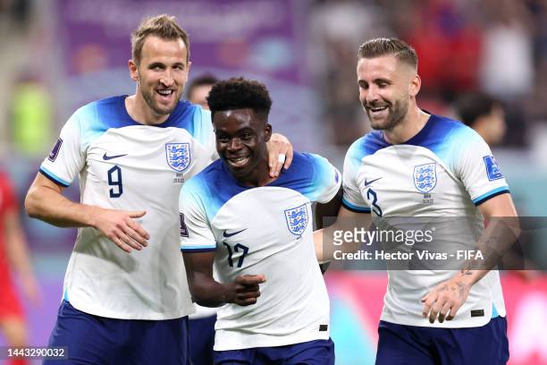 Bukayo Saka of England celebrates with Harry Kane and Luke Shaw after scoring their team's fourth goal during the FIFA World Cup Qatar 2022 Group B...