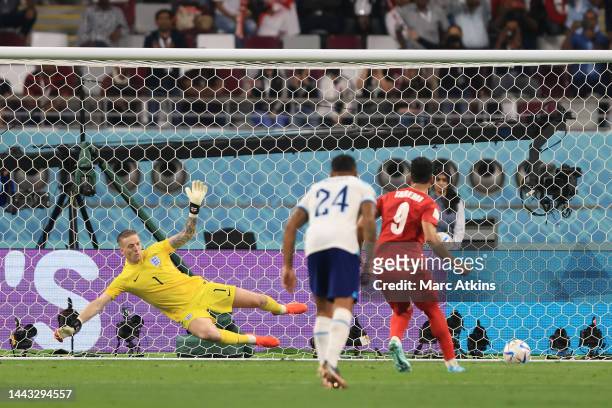Mehdi Taremi of IR Iran scores a penalty for his team's second goal past Jordan Pickford of England during the FIFA World Cup Qatar 2022 Group B...