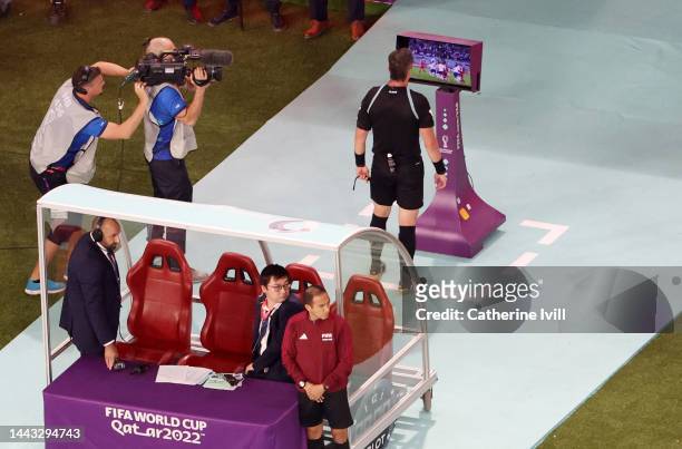 Referee Raphael Claus checks the VAR screen which results in a possible penalty to IR Iran, which was later given during the FIFA World Cup Qatar...