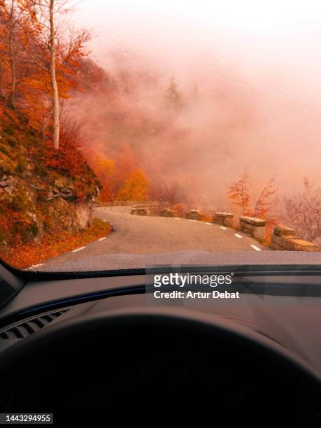 driving a car in a beautiful nature environment with extreme weather conditions. - action camera stock pictures, royalty-free photos & images