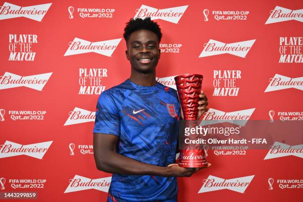 Bukayo Saka of England poses with the Budweiser Player of the Match trophy following the FIFA World Cup Qatar 2022 Group B match between England and...