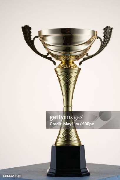 close up of golden trophy against white background,malaysia - trophy display stock pictures, royalty-free photos & images