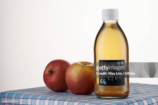 apple cider vinegar on checker cloth against white background,malaysia - apple cider vinegar stock pictures, royalty-free photos & images