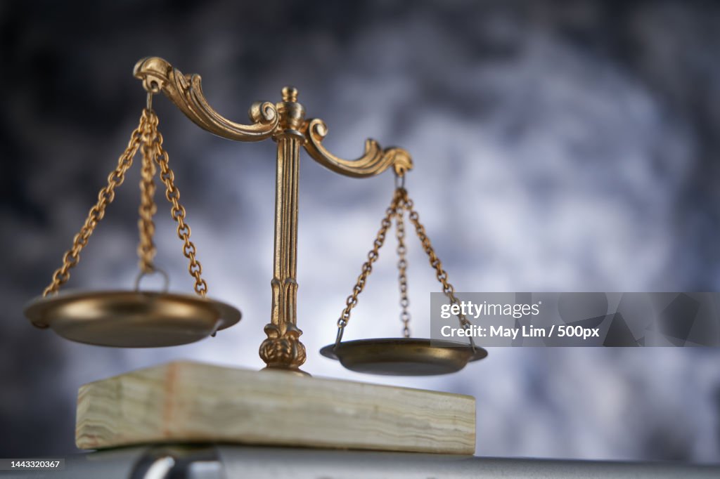 Close up of libra scale against gray background,Malaysia