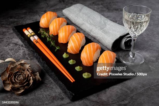 high angle view of sushi on table - fresh wasabi stock-fotos und bilder