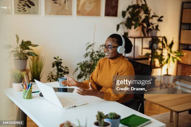 female african entrepreneur working from green office, having video call with remote partners and coworkers - zoom webinar stock pictures, royalty-free photos & images