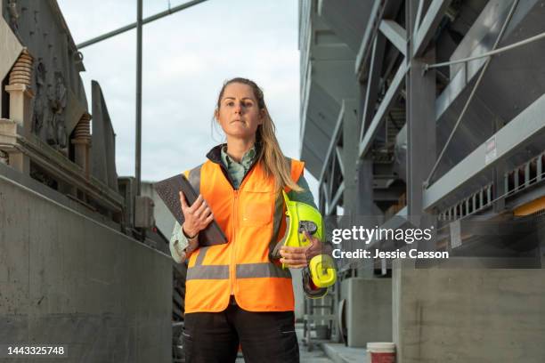 portrait of a female construction worker at a concrete manufacturing plant - construction worker pose stock pictures, royalty-free photos & images