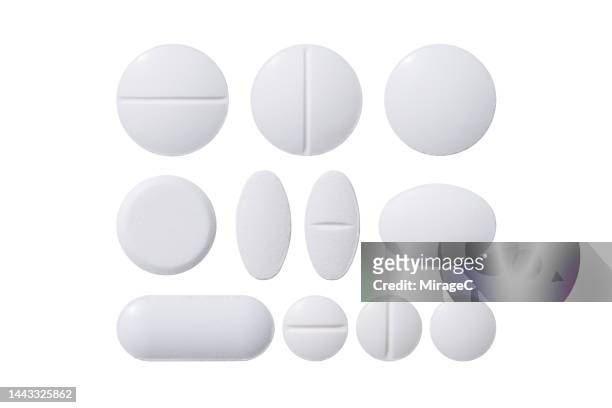 white pills of various shapes isolated on white - tablet stock pictures, royalty-free photos & images