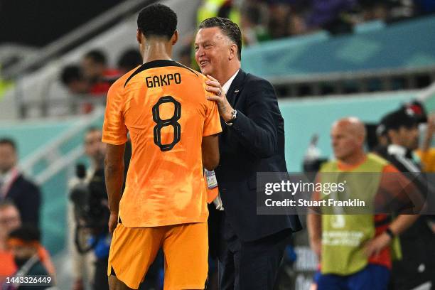 Cody Gakpo of Netherlands celebrates with Louis van Gaal, Head Coach of Netherlands, after scoring their team's first goal during the FIFA World Cup...