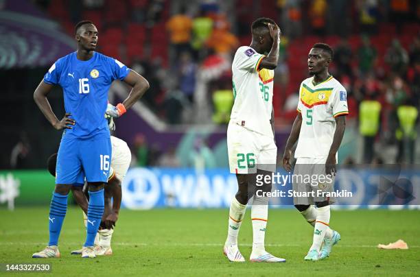 Edouard Mendy, Pape Gueye and Idrissa Gana Gueye of Senegal react after the 2-0 loss during the FIFA World Cup Qatar 2022 Group A match between...