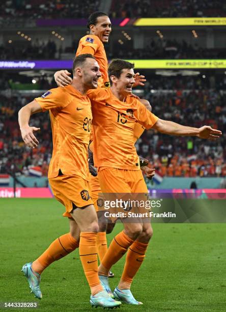 Teun Koopmeiners, Marten de Roon and Virgil Van Dijk of Netherlands celebrate after their team's second goal by Davy Klaassen during the FIFA World...