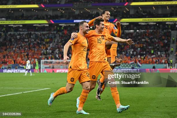 Teun Koopmeiners, Marten de Roon and Virgil Van Dijk of Netherlands celebrate after their team's second goal by Davy Klaassen during the FIFA World...