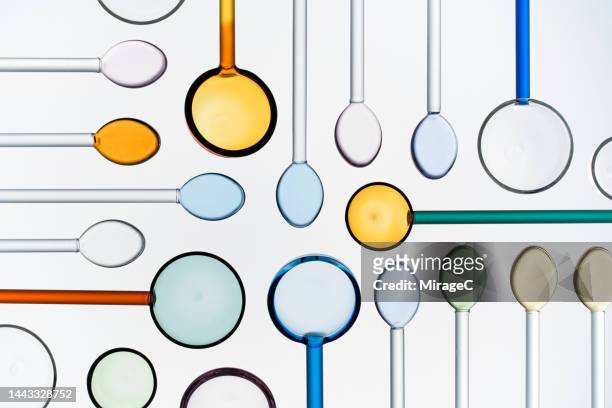 a variety of multi colored glass spoons flat lay on white - elegant spoon stock pictures, royalty-free photos & images
