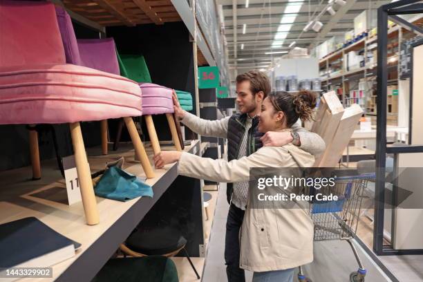 mixed race couple choosing furniture - straight haircut stock pictures, royalty-free photos & images