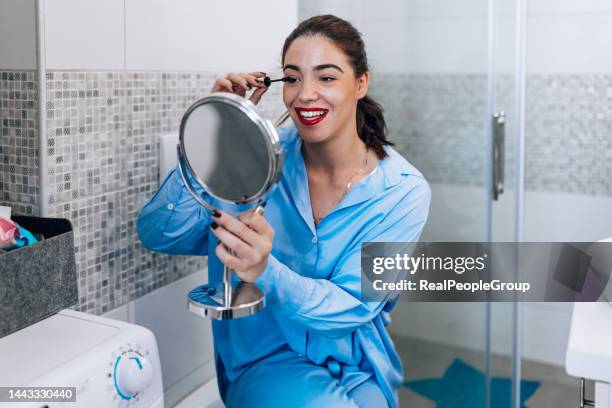 getting ready for work - blue mascara stockfoto's en -beelden