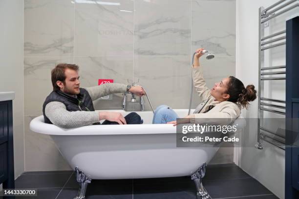 couple choosing a bathroom - shower man woman washing foto e immagini stock