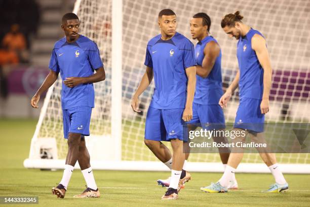 Kylian Mbappe and Ousmane Dembele of France look on during France Training Session at Jassim Bin Hamad Stadium on November 21, 2022 in Doha, Qatar.