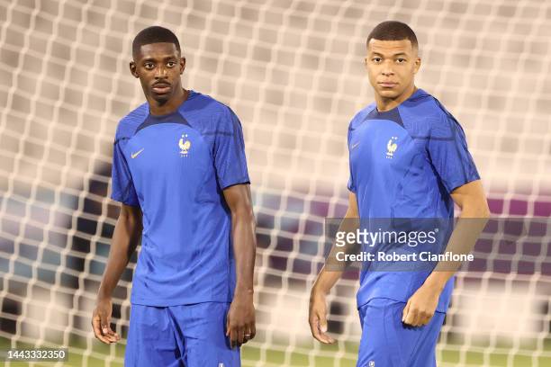 Kylian Mbappe and Ousmane Dembele of France look on during France Training Session at Jassim Bin Hamad Stadium on November 21, 2022 in Doha, Qatar.