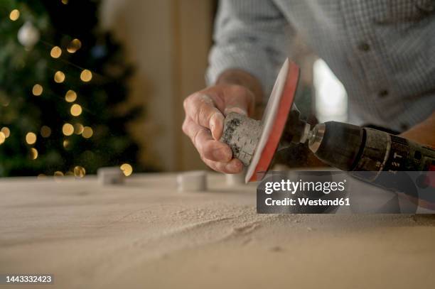 craftsman shaping wood through grinder - machine christmas tree stock pictures, royalty-free photos & images