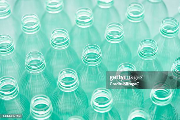 aqua green colored plastic bottles arranged in rows - disposable stock pictures, royalty-free photos & images