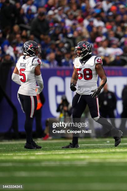 Christian Kirksey of the Houston Texans and Jalen Pitre celebrate against the New York Giants at MetLife Stadium on November 13, 2022 in East...