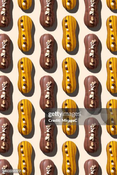 chocolate eclair desserts repetition pattern - eclair stock pictures, royalty-free photos & images