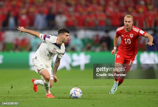Christian Pulisic of United States is challenged by Aaron Ramsey of Wales during the FIFA World Cup Qatar 2022 Group B match between USA and Wales at...