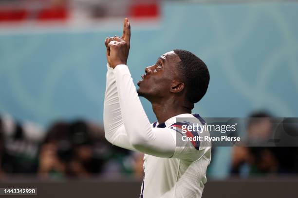 Timothy Weah of United States celebrates after scoring their team's first goal during the FIFA World Cup Qatar 2022 Group B match between USA and...