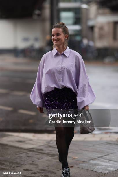 Marlene Fey seen wearing SoSUE light purple blouse Antonia, H&M short glitter skirt, VeeCollective beige mini handbag, Zara golden earrings, Dr....