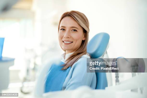 at the dentist for her regular check-up - cadeira de dentista imagens e fotografias de stock