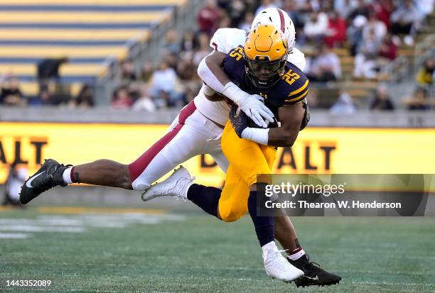 DeCarlos Brooks of the California Golden Bears gets tackled by Levani Damuni of the Stanford Cardinal during the first quarter of an NCAA football...