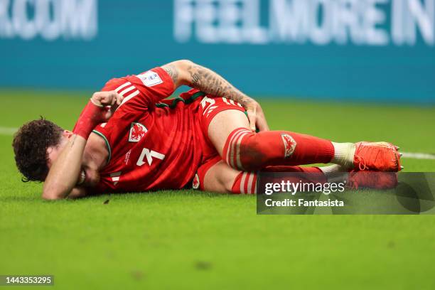 Neco Williams of Wales reacts as he lays on the turf grapsing his hamstring during the FIFA World Cup Qatar 2022 Group B match between USA and Wales...