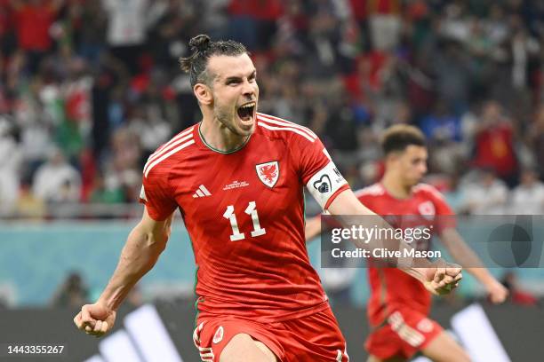 Gareth Bale of Wales celebrates after scoring their team's first goal via a penalty during the FIFA World Cup Qatar 2022 Group B match between USA...