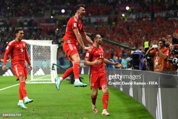 Gareth Bale of Wales celebrates with Kieffer Moore after scoring their team's first goal via a penalty past Matt Turner of United States during the...