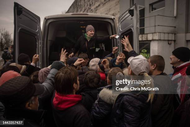 Residents crowd around to take basic medicine supplies at an aid hub on November 21, 2022 in Kherson, Ukraine. Ukrainian forces took control of...