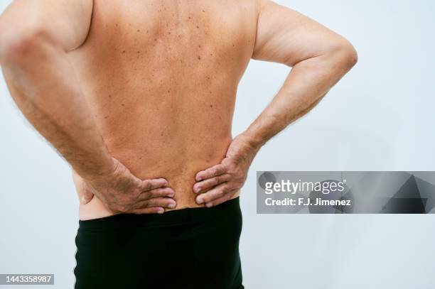 close-up of senior man complaining of back pain - exercise kidney stock-fotos und bilder