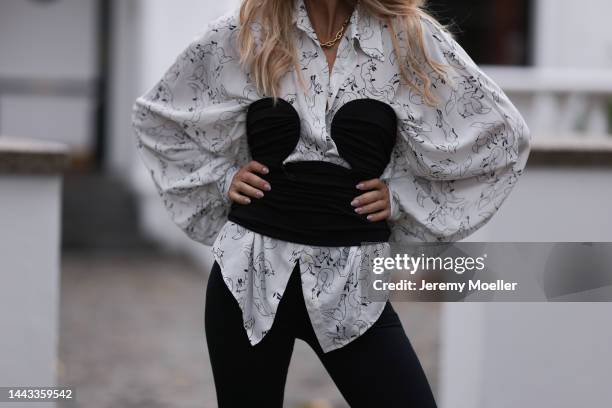 Sue Giers seen wearing SoSUE Antonia Fox white blouse, SoSUE Slit black Leggings, Pixie Market black corsage, Ysl black heels on November 17, 2022 in...