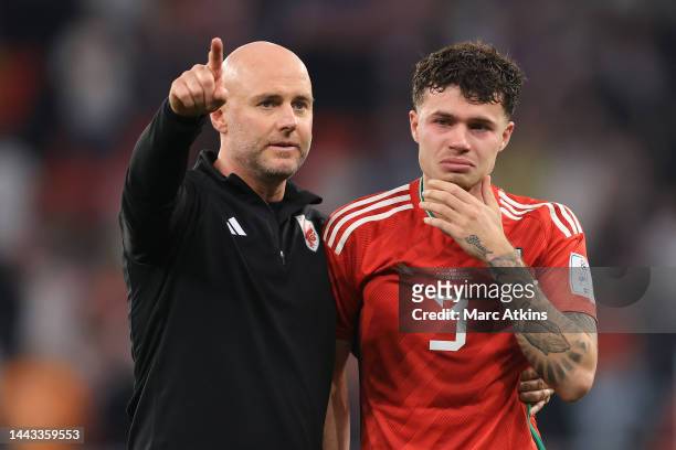 Rob Page, Manager of Wales embraces Neco Williams of Wales as he is seen to be emotional after his team's result in the FIFA World Cup Qatar 2022...